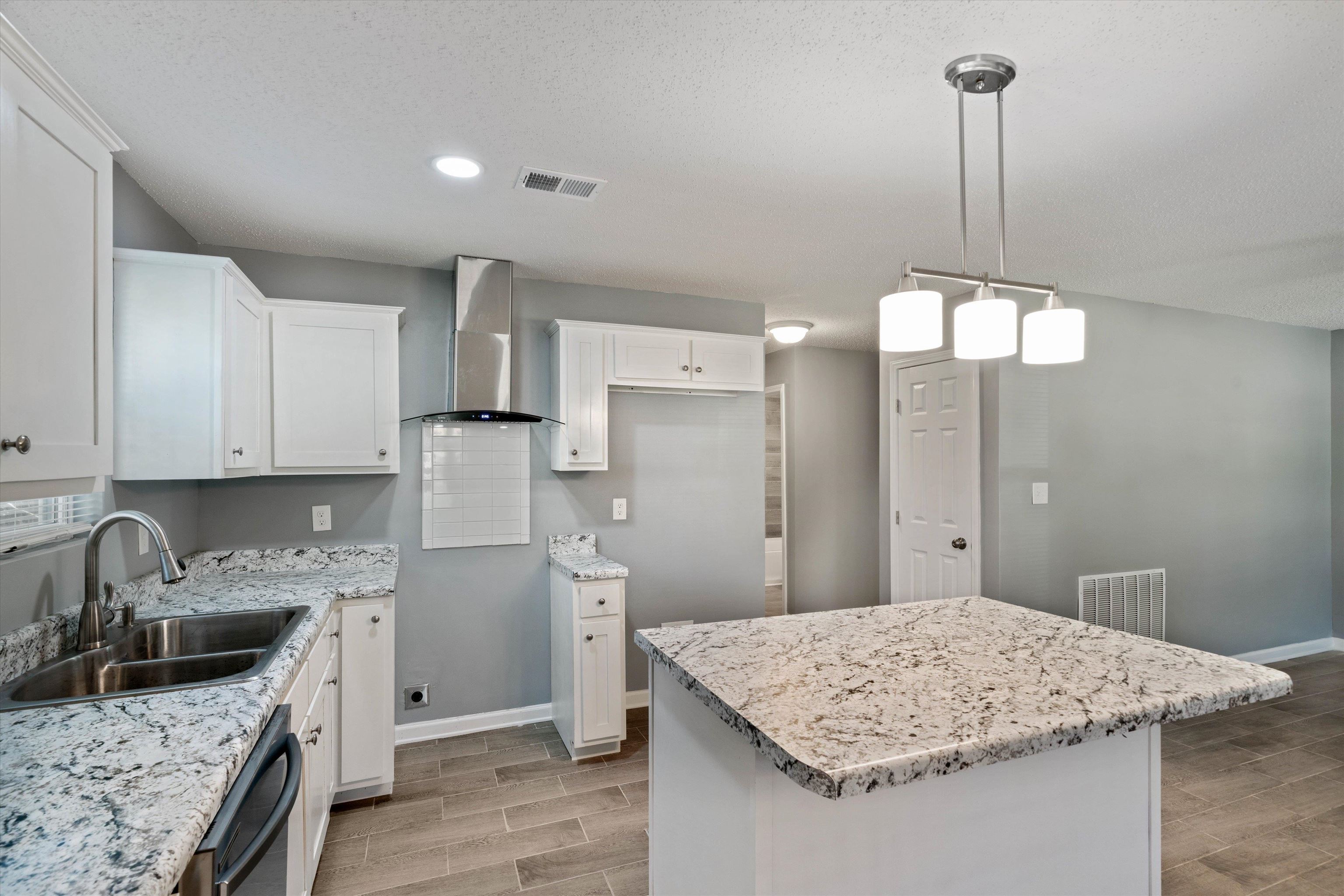 487 Delta Road Memphis, TN 38109 - Photo 13 of 25 a kitchen with stainless steel appliances granite countertop a sink refrigerator and cabinets