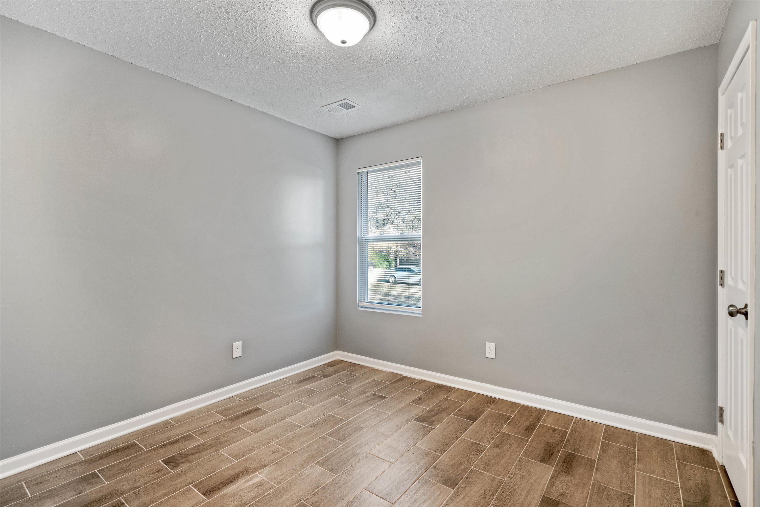 487 Delta Road Memphis, TN 38109 - Photo 22 of 25 a view of a room with wooden floor and window