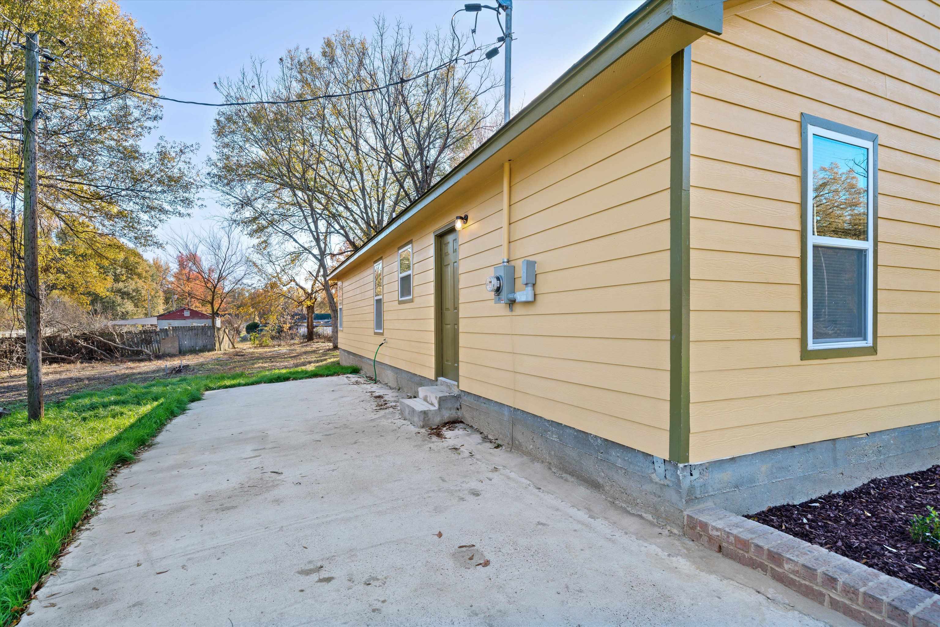 487 Delta Road Memphis, TN 38109 - Photo 24 of 25 a view of a house with backyard and trees