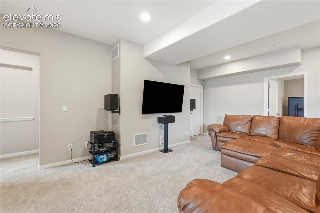 1394 Promontory Bluff View Colorado Springs, CO 80921 - Photo 35 of 47 a living room with furniture and a flat screen tv