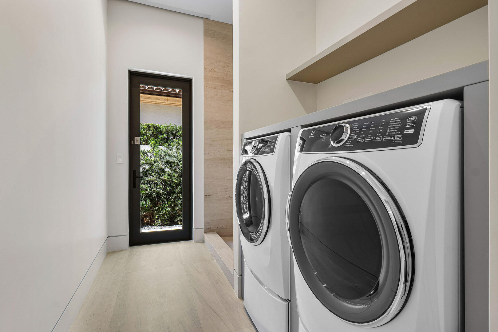 224 West Key Palm Road Boca Raton, FL 33432 - Photo 35 of 101 a view of washer and dryer with kitchen in the background