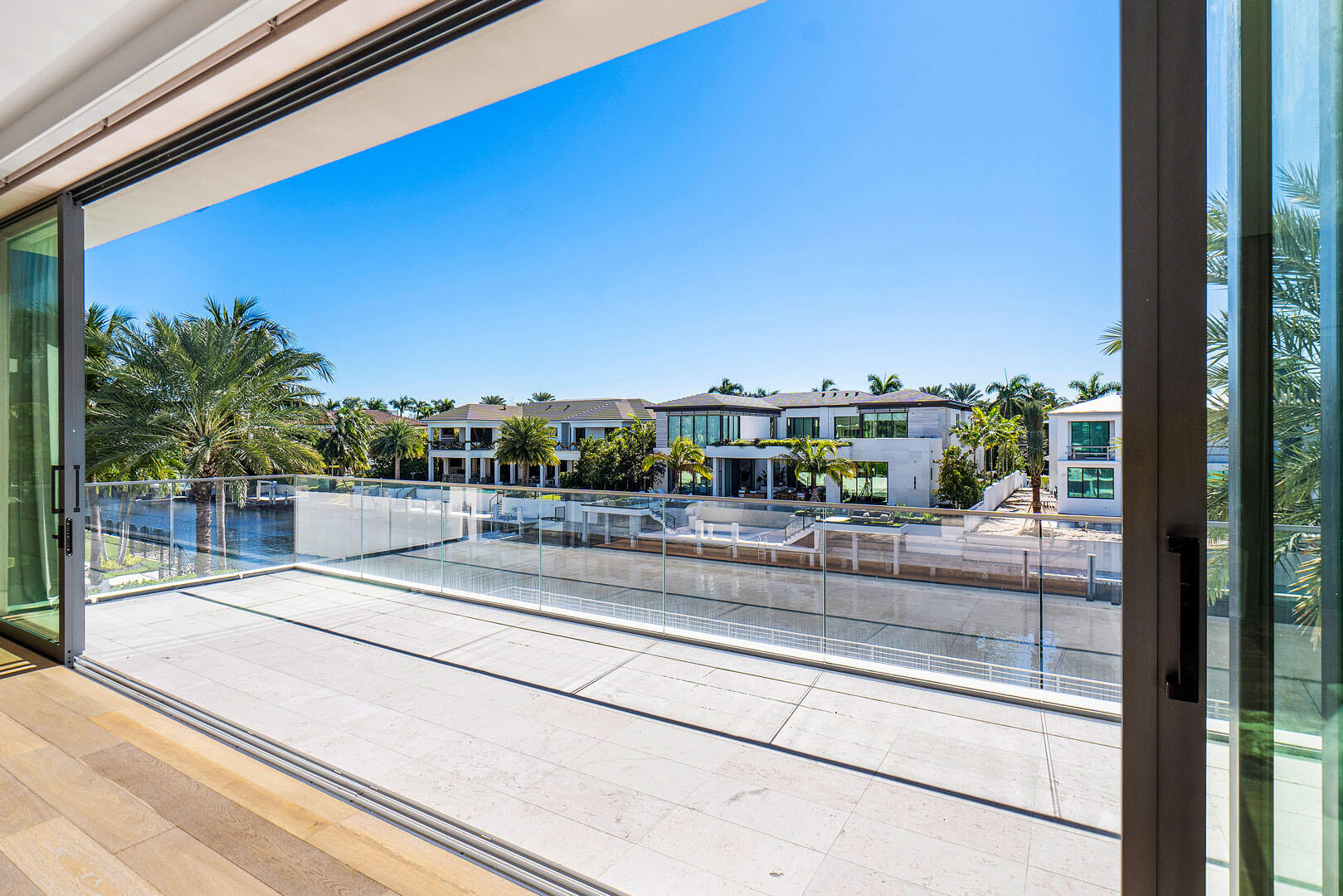 224 West Key Palm Road Boca Raton, FL 33432 - Photo 52 of 101 a view of a balcony with a floor to ceiling window and potted plants