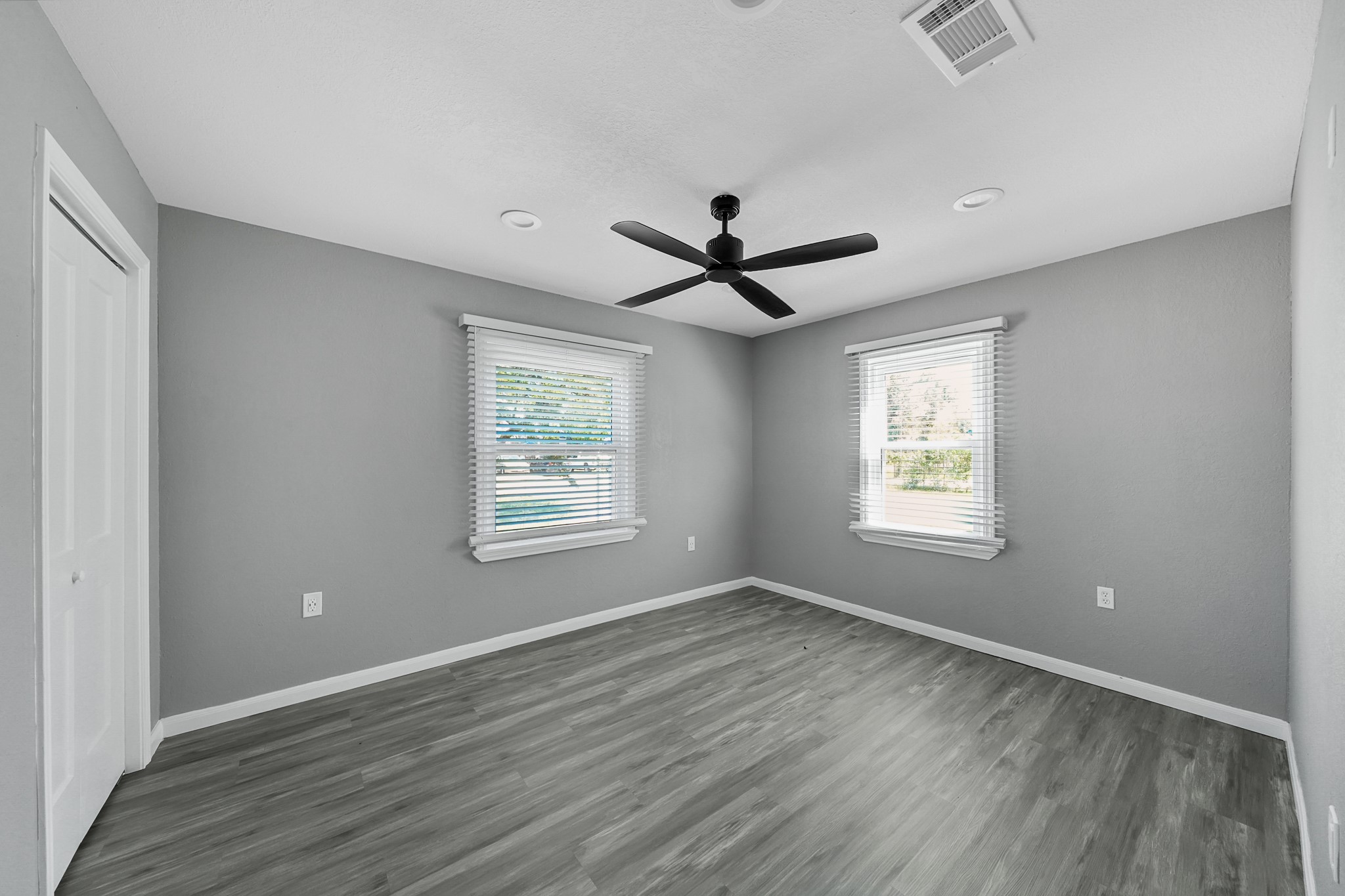 7323 Farnsworth Street Houston, TX 77022 - Photo 12 of 23 a view of a big room with wooden floor and windows