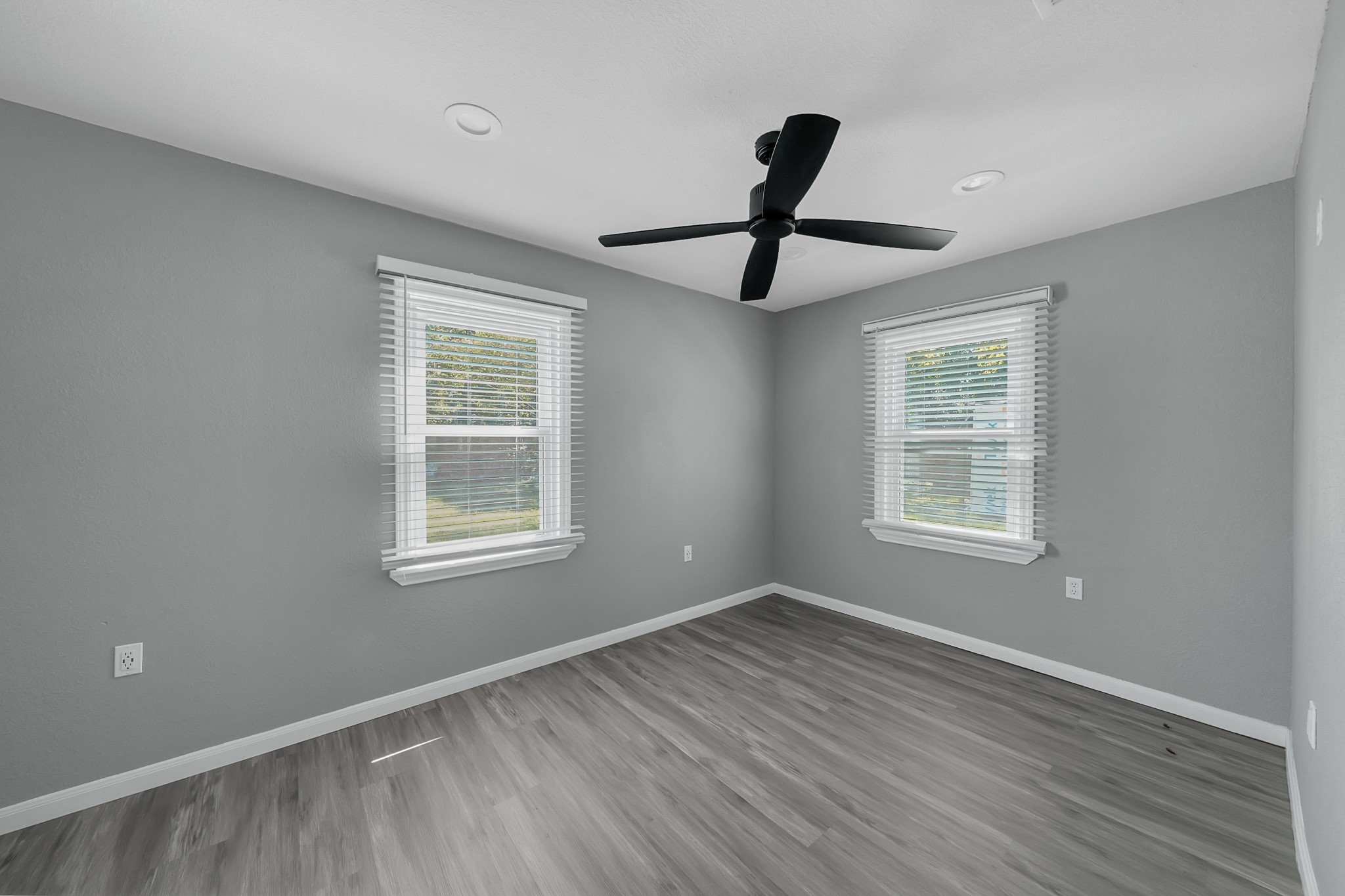 7323 Farnsworth Street Houston, TX 77022 - Photo 13 of 23 a view of an empty room with window and wooden floor