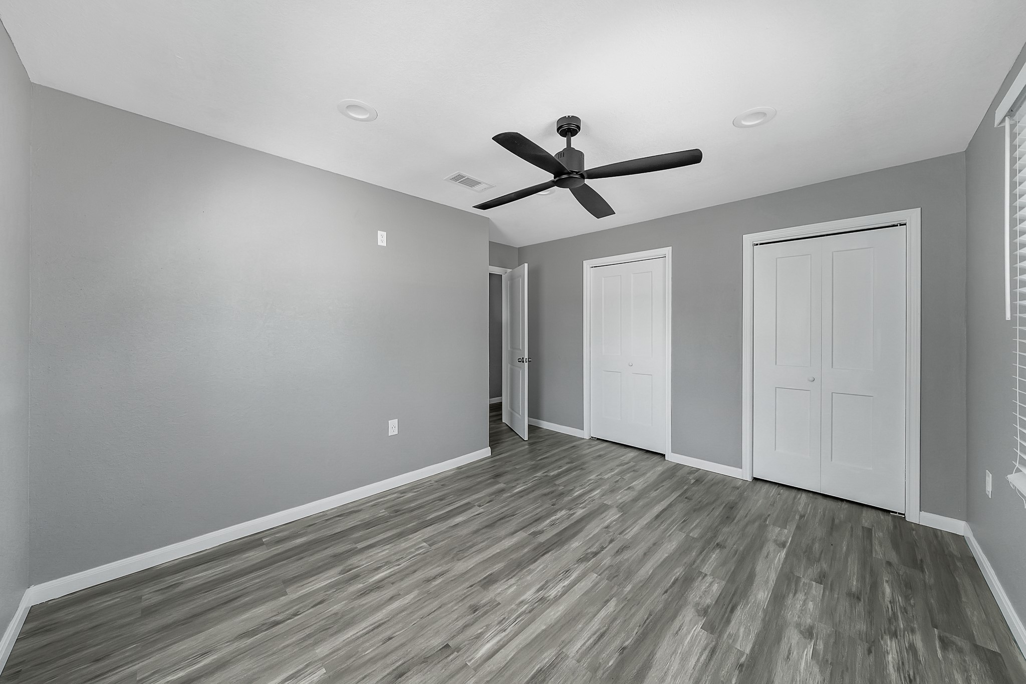 7323 Farnsworth Street Houston, TX 77022 - Photo 14 of 23 a view of a big room with wooden floor and a ceiling fan