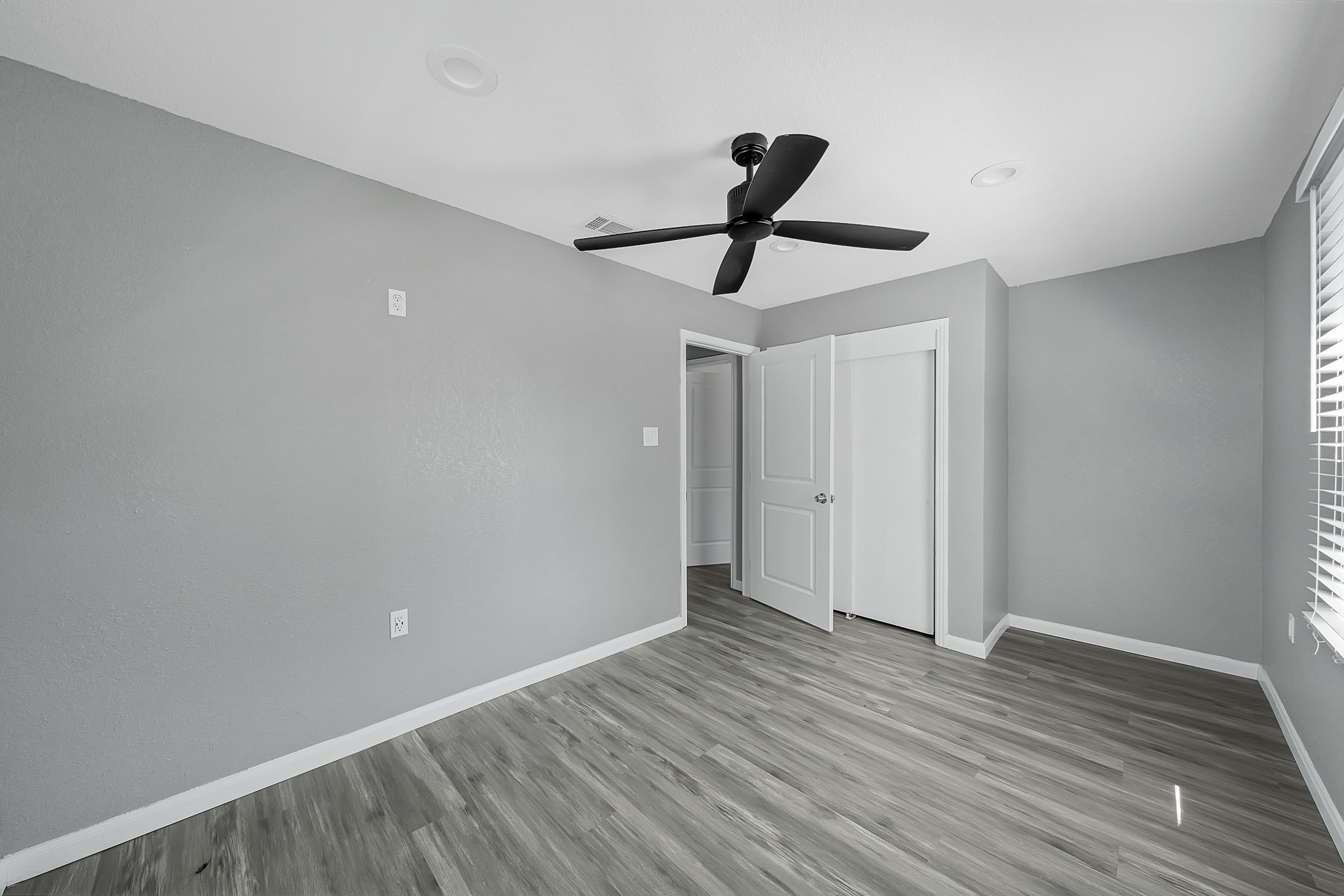 7323 Farnsworth Street Houston, TX 77022 - Photo 15 of 23 a view of room with wooden floor and window