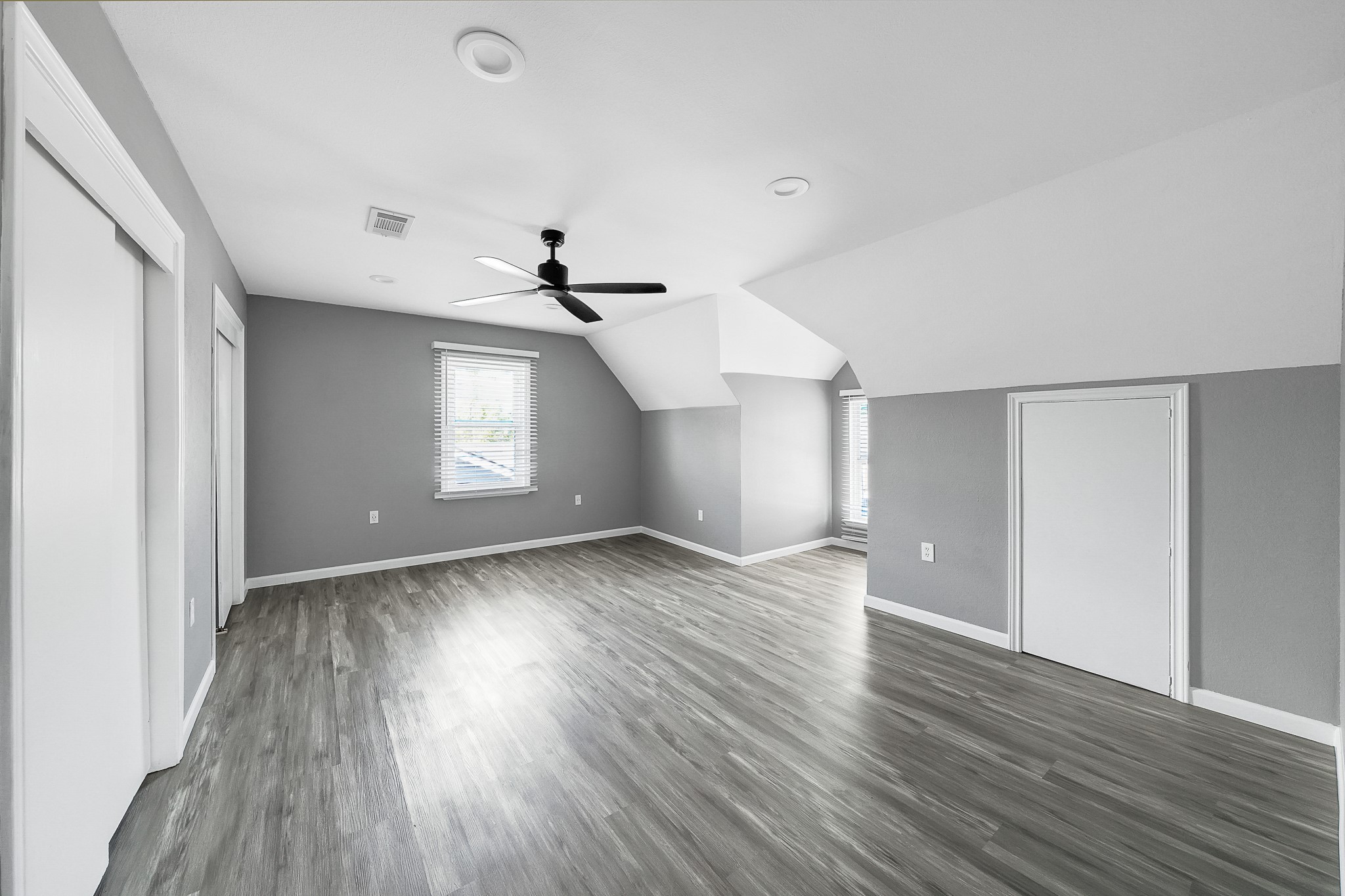 7323 Farnsworth Street Houston, TX 77022 - Photo 17 of 23 an empty room with wooden floor and windows