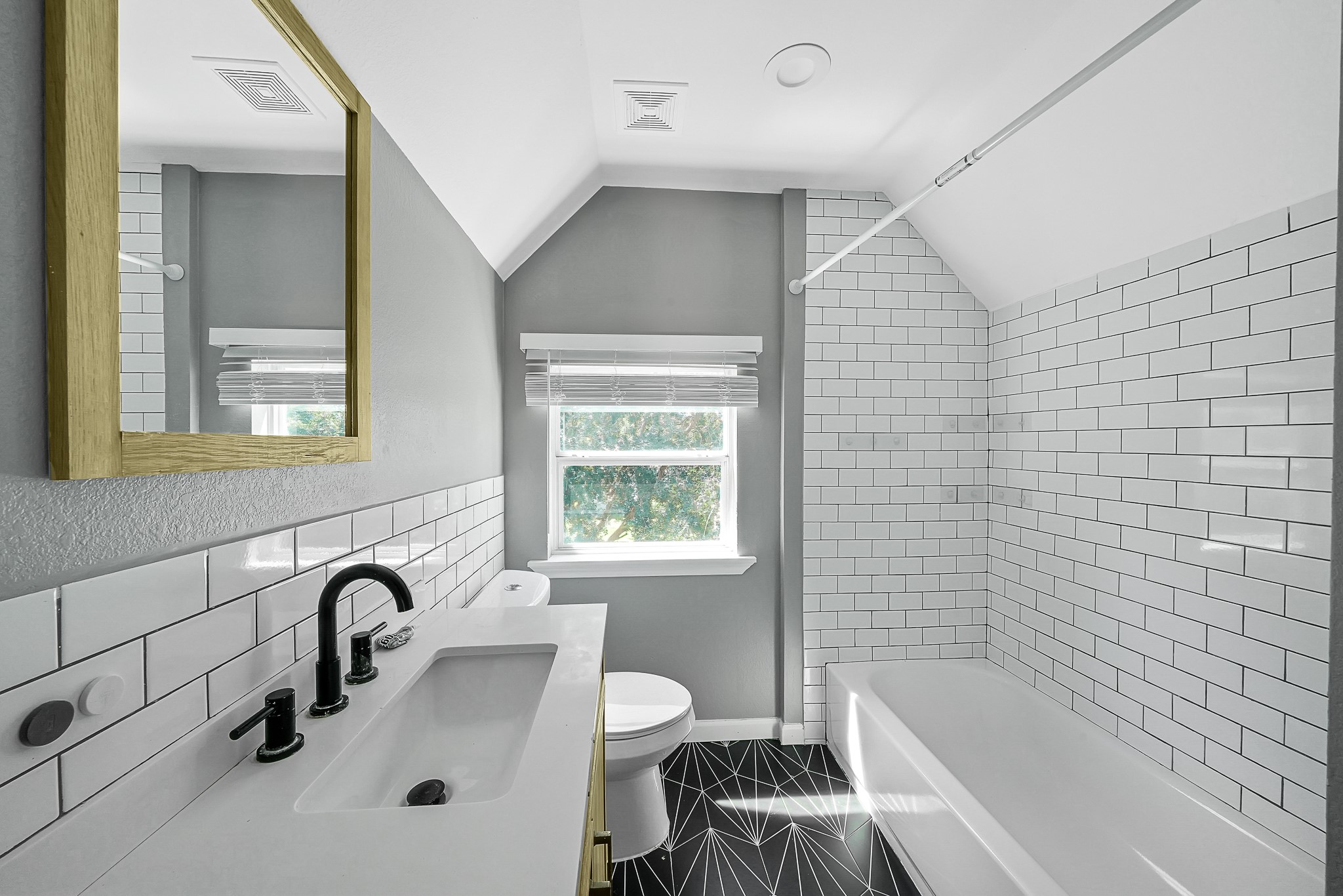 7323 Farnsworth Street Houston, TX 77022 - Photo 19 of 23 a bathroom with a sink a bathtub and a shower