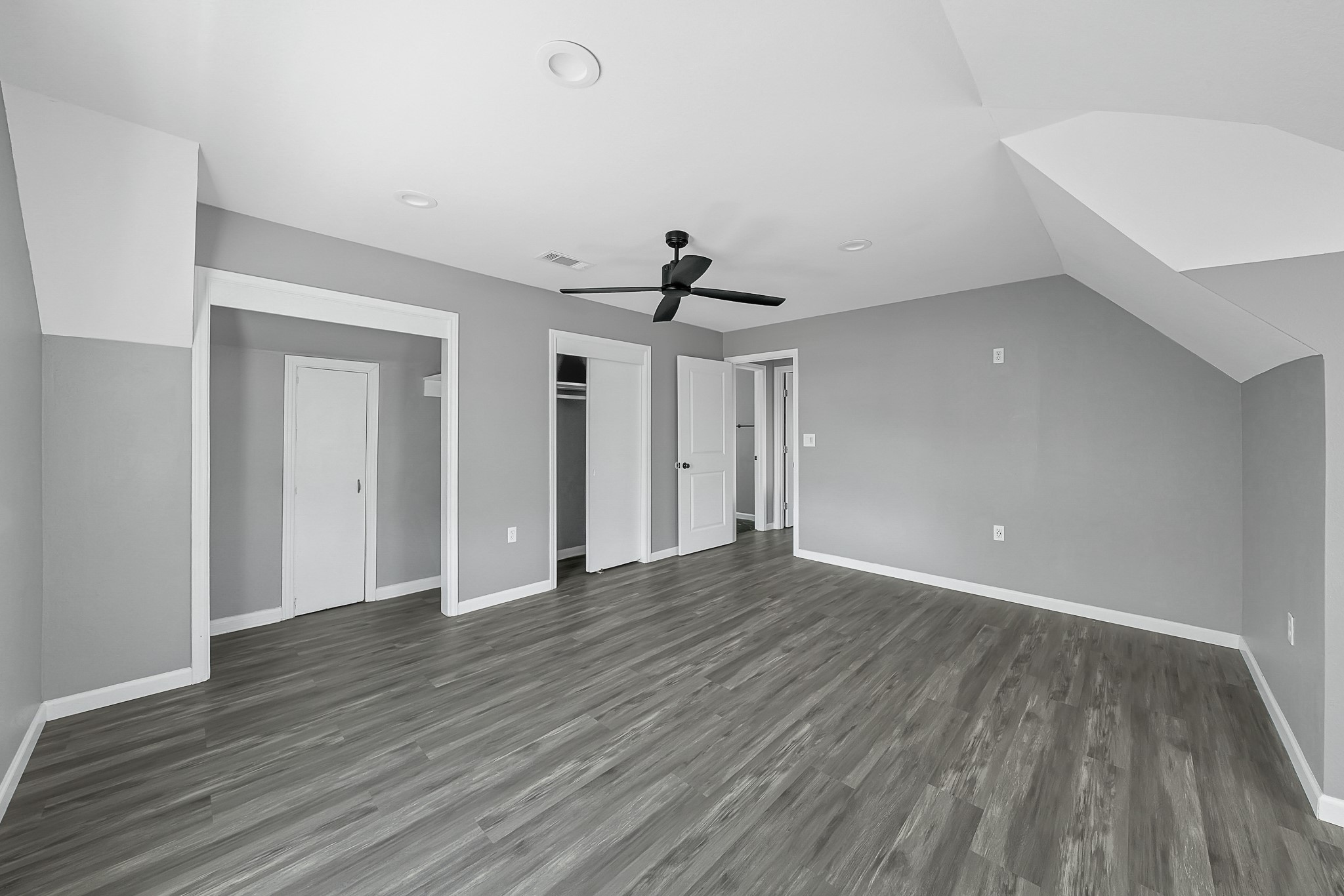 7323 Farnsworth Street Houston, TX 77022 - Photo 21 of 23 a view of an empty room with wooden floor and a ceiling fan