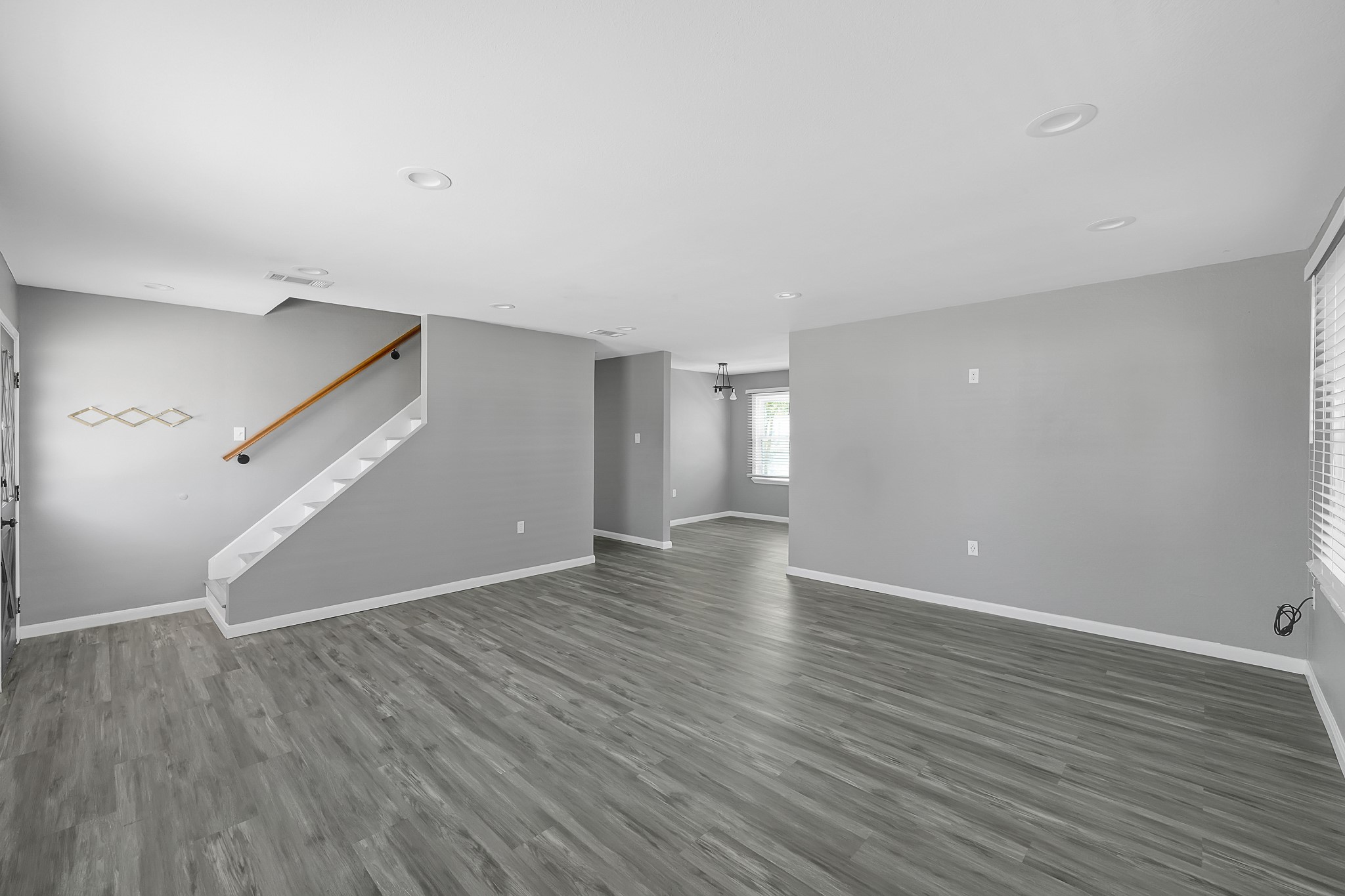 7323 Farnsworth Street Houston, TX 77022 - Photo 4 of 23 a view of an empty room with wooden floor and a window
