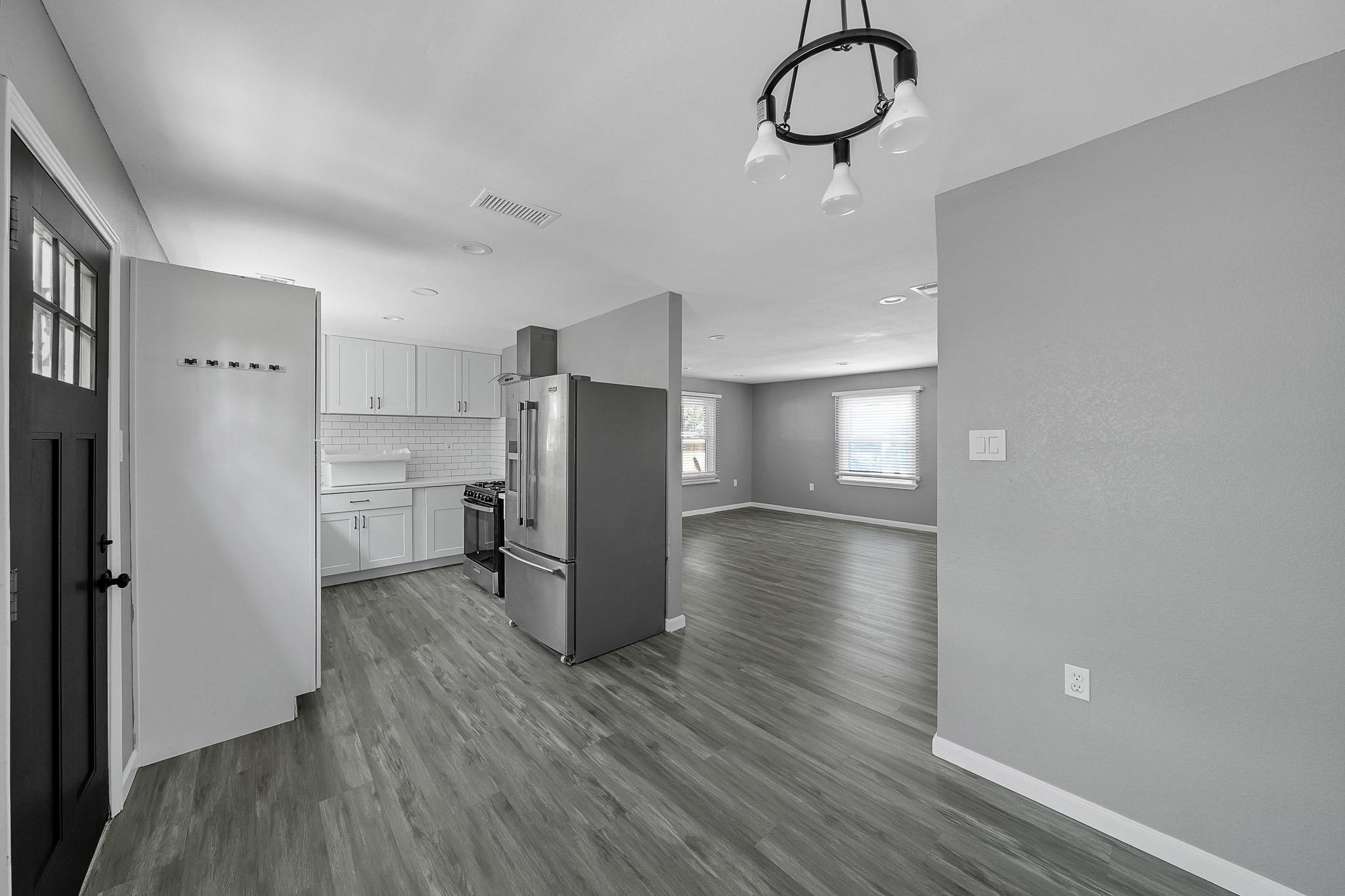 7323 Farnsworth Street Houston, TX 77022 - Photo 8 of 23 a view of a kitchen with a refrigerator and wooden floor