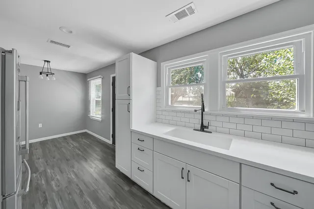 a kitchen with sink and windows