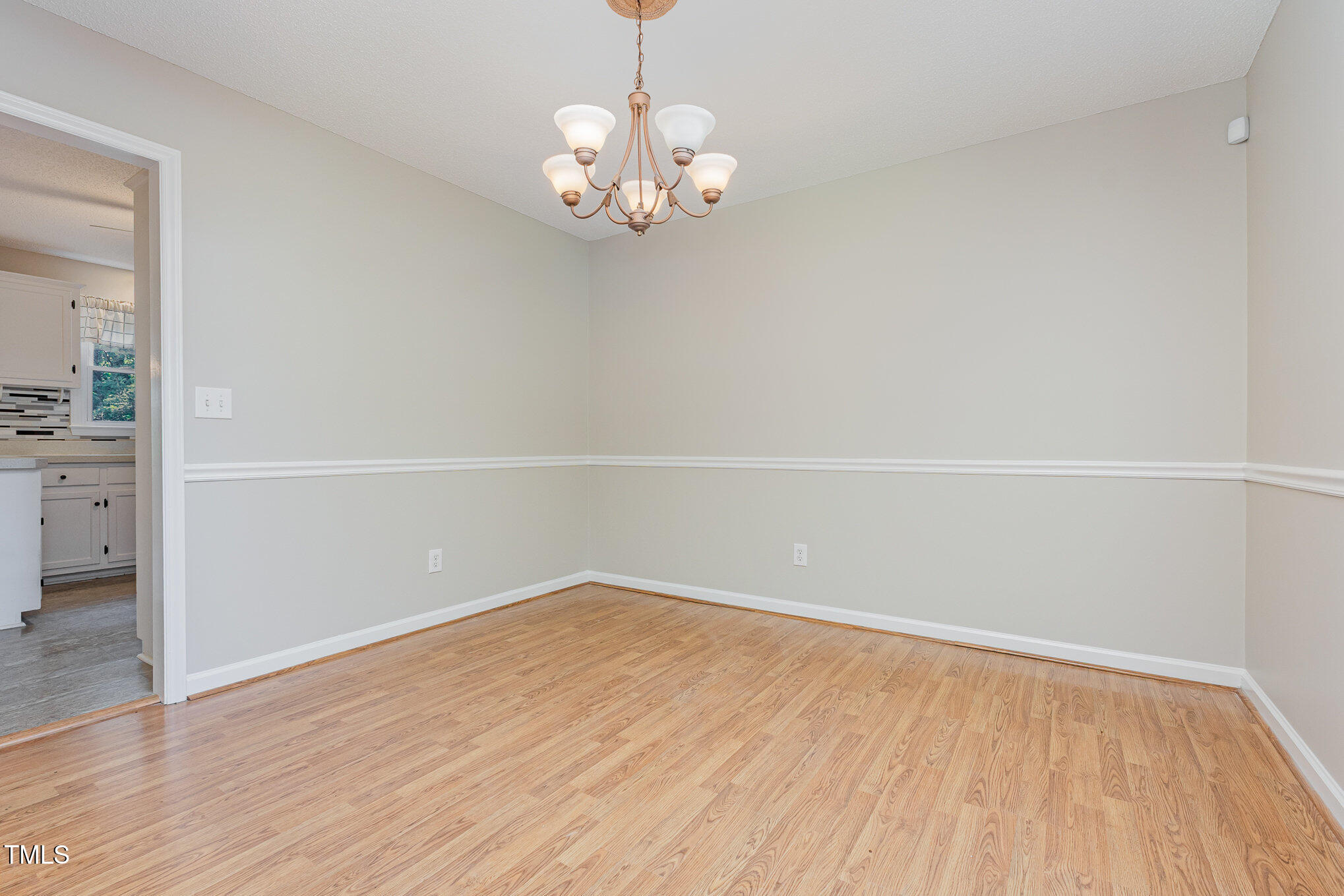 637 Coachman Way Sanford, NC 27332 - Photo 11 of 26 wooden floor in an empty room with a window