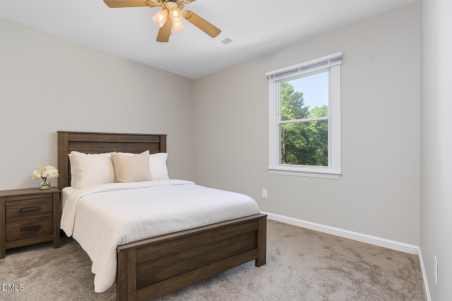 637 Coachman Way Sanford, NC 27332 - Photo 17 of 26 a bedroom with a bed and window