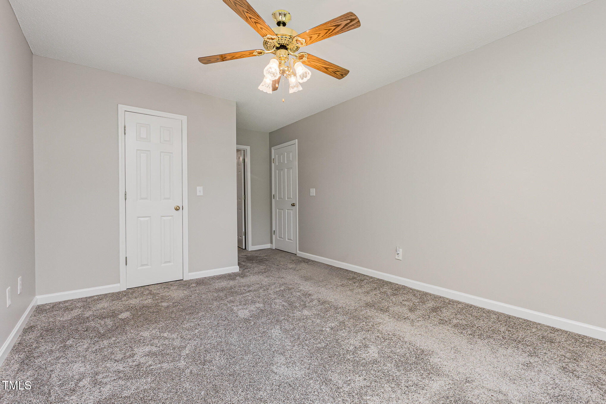 637 Coachman Way Sanford, NC 27332 - Photo 22 of 26 an empty room with closet and a chandelier fan