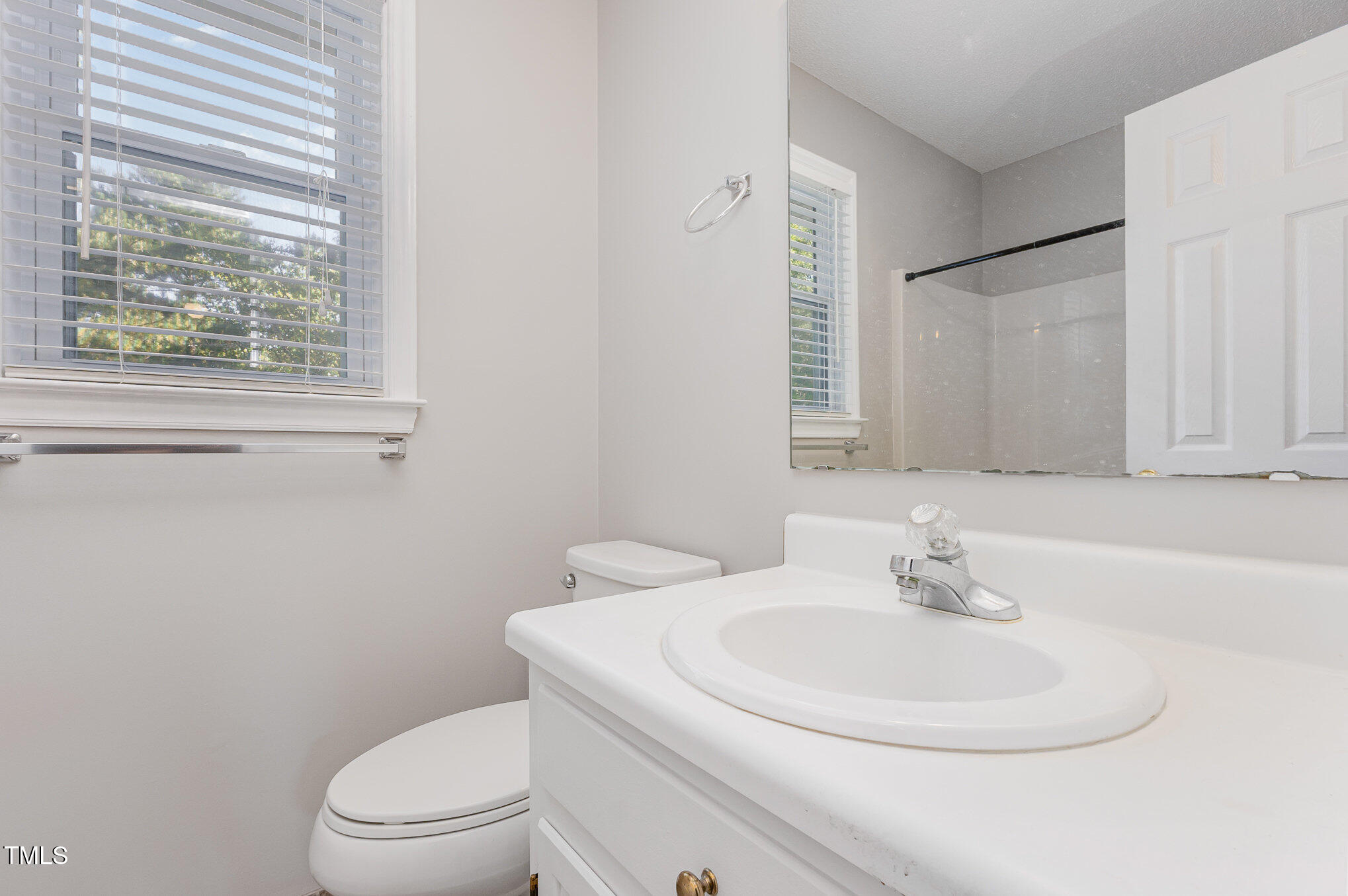 637 Coachman Way Sanford, NC 27332 - Photo 23 of 26 a bathroom with a sink a toilet and a mirror