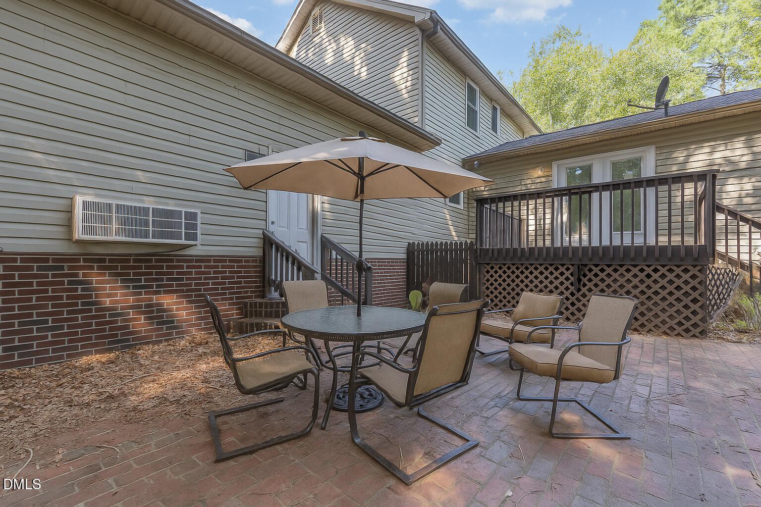 637 Coachman Way Sanford, NC 27332 - Photo 24 of 26 a balcony with table and chairs
