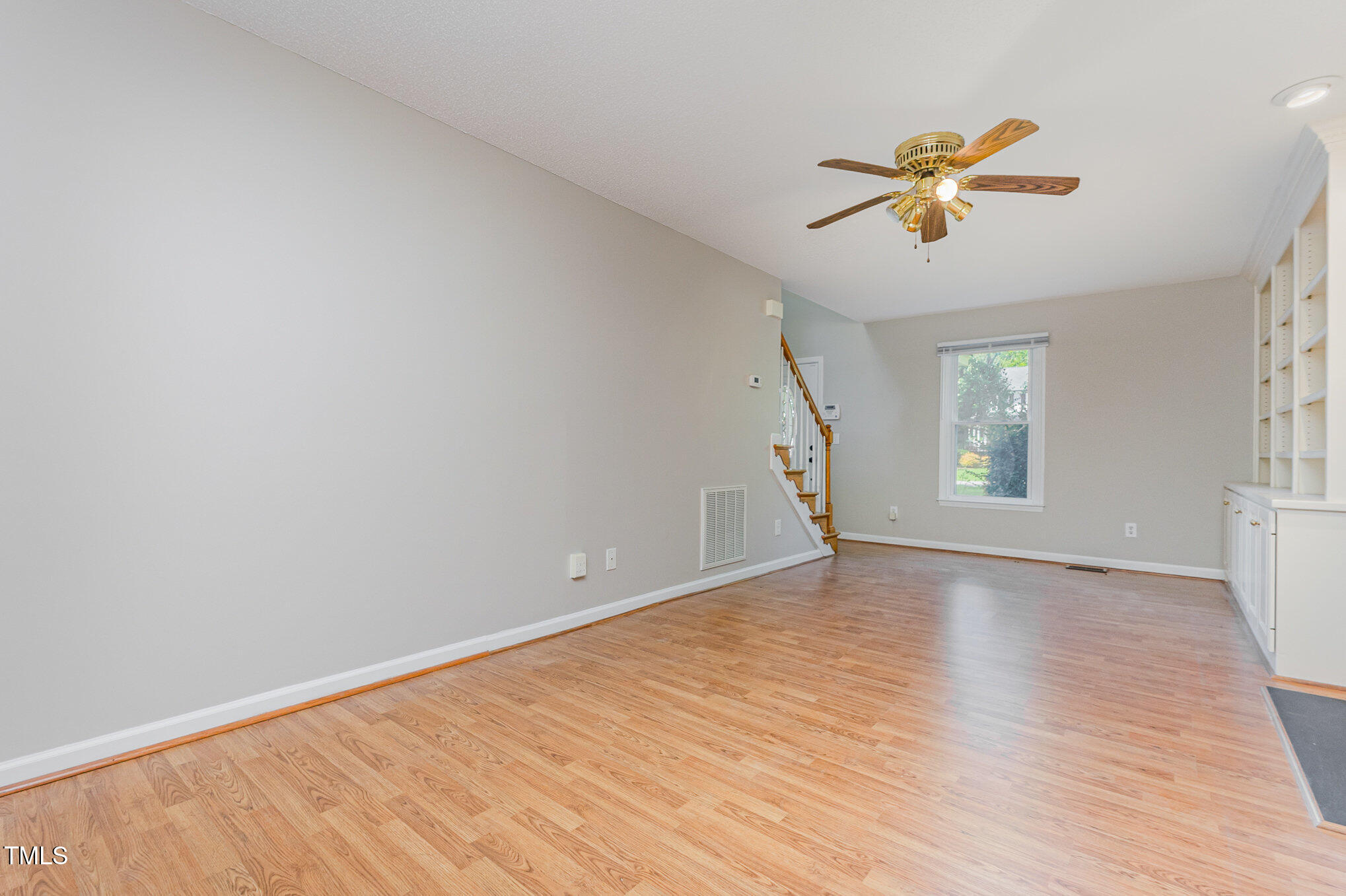 637 Coachman Way Sanford, NC 27332 - Photo 3 of 26 a view of an empty room with window and wooden floor