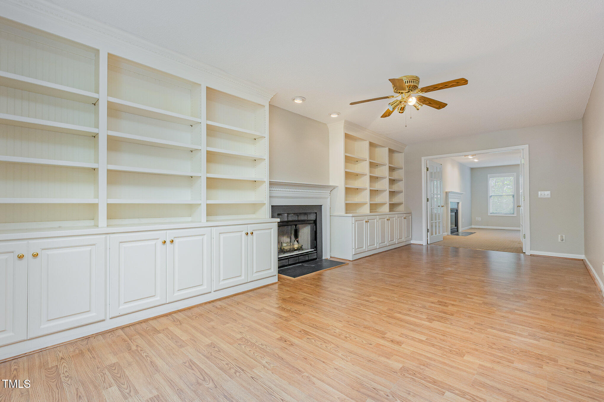 637 Coachman Way Sanford, NC 27332 - Photo 4 of 26 a view of a livingroom with a fireplace a ceiling fan and entryway