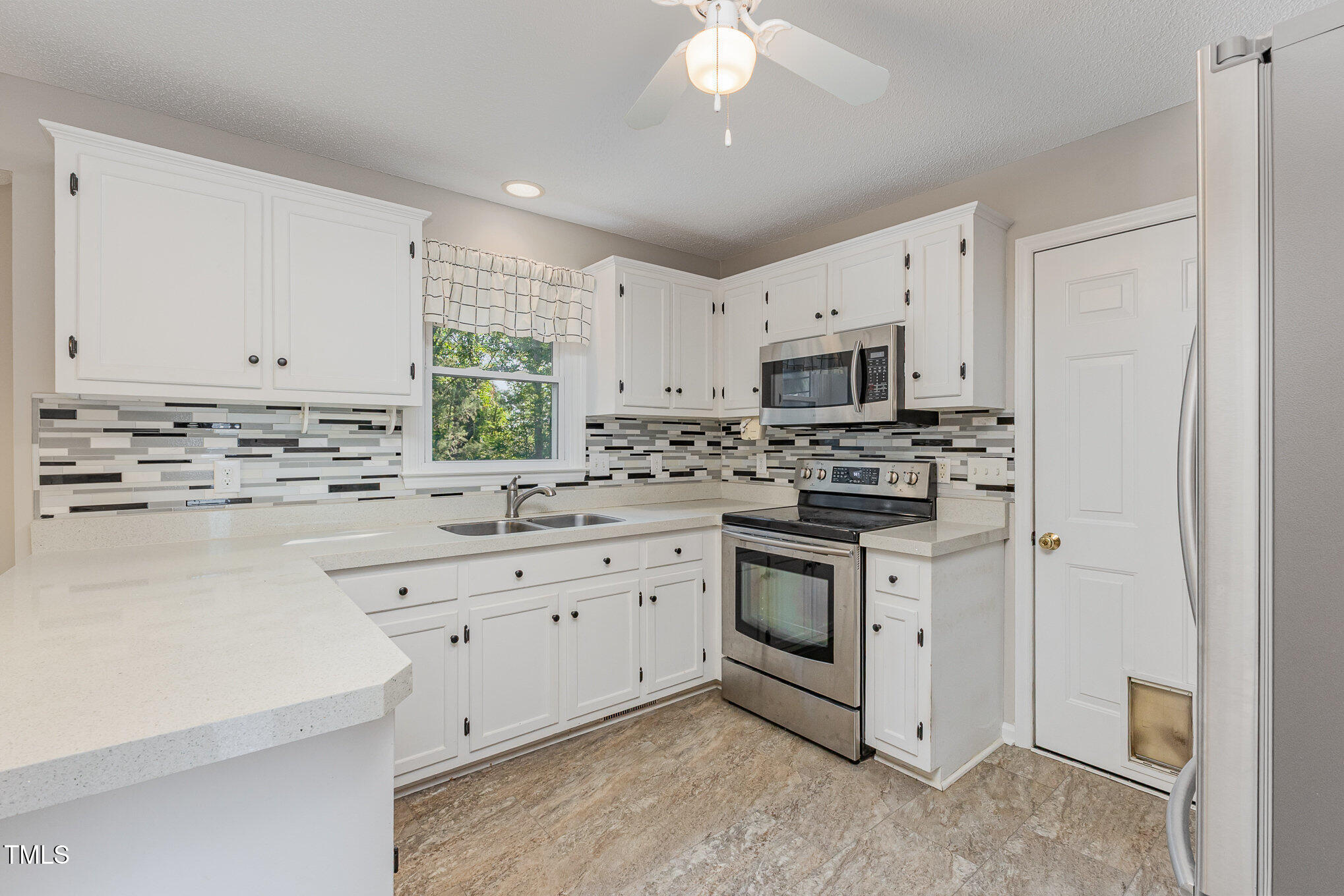 637 Coachman Way Sanford, NC 27332 - Photo 8 of 26 a kitchen with granite countertop white cabinets and white stainless steel appliances