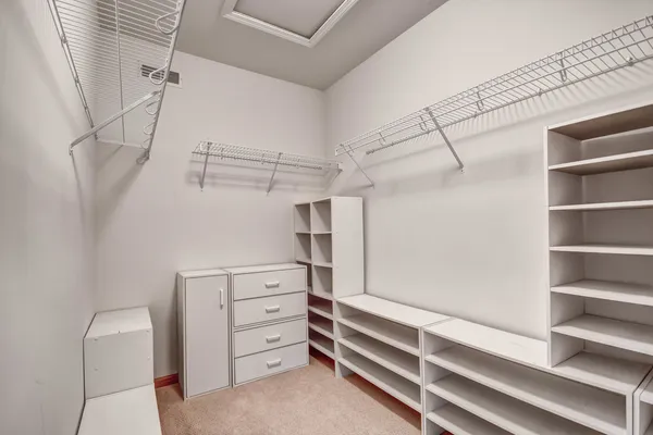 a view of walk in closet with empty racks