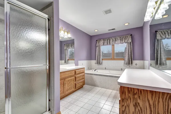 a bathroom with a sink a large mirror and a bathtub