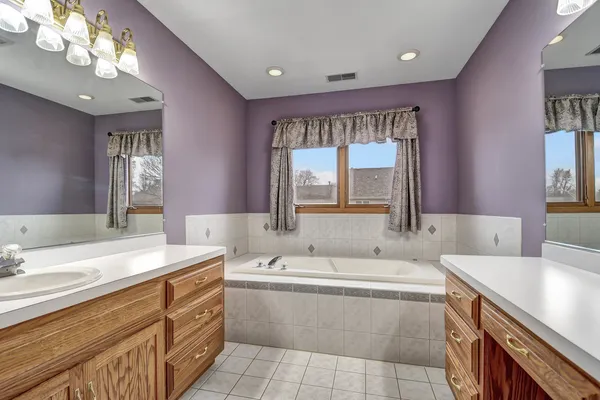 a bathroom with a sink a mirror and a shower