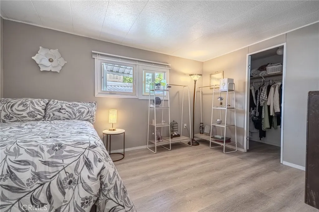 9340 Foothill, Unit 68 Rancho Cucamonga, CA 91730 - Photo 13 of 30 a bedroom with a bed and a chandelier