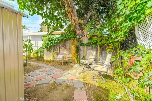 a view of a patio with table and chairs and potted plants