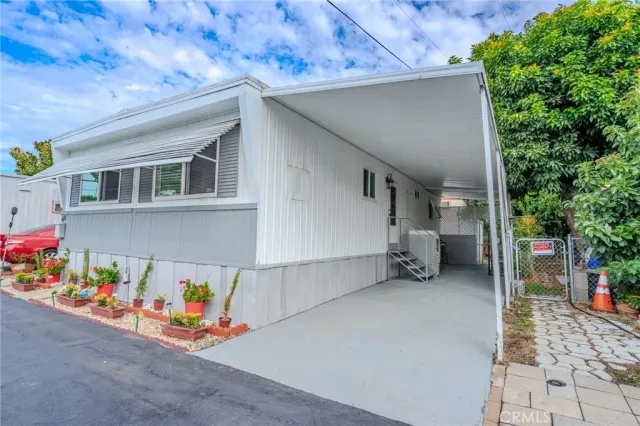 a dining room with wooden floor a chandelier a glass table and chairs