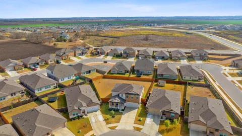 an aerial view of residential houses and outdoor space