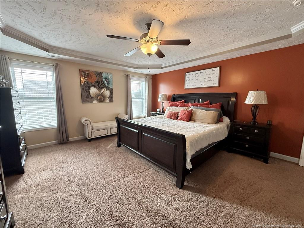 35 Ambrose Point Cameron, NC 28326 - Photo 19 of 31 a bedroom with a bed and a chandelier