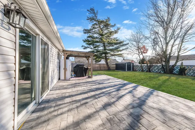 a view of a house with a yard and large tree