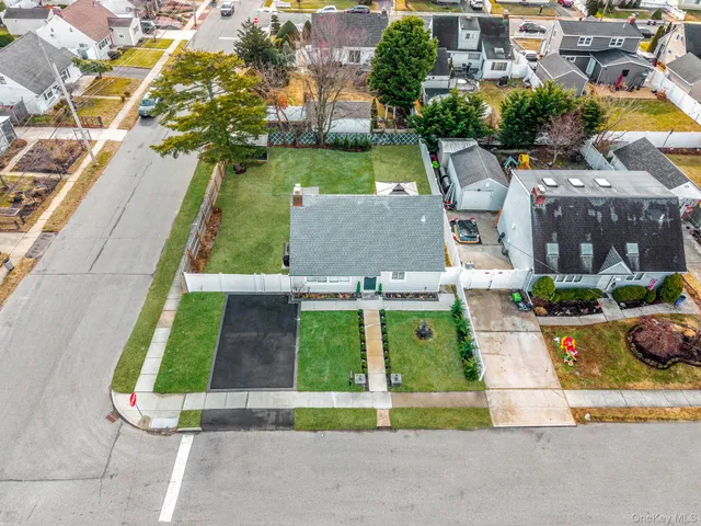 an aerial view of a house with garden space and street view