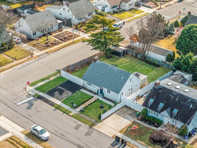 an aerial view of a house with a garden and swimming pool