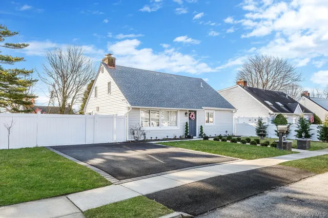 a view of the house with a yard