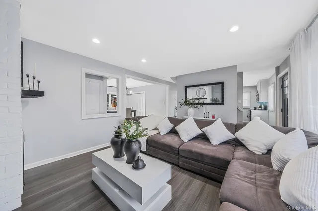 a living room with furniture potted plant and a window