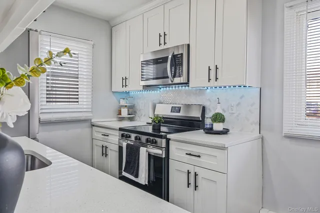 a kitchen with stainless steel appliances granite countertop a sink and a stove