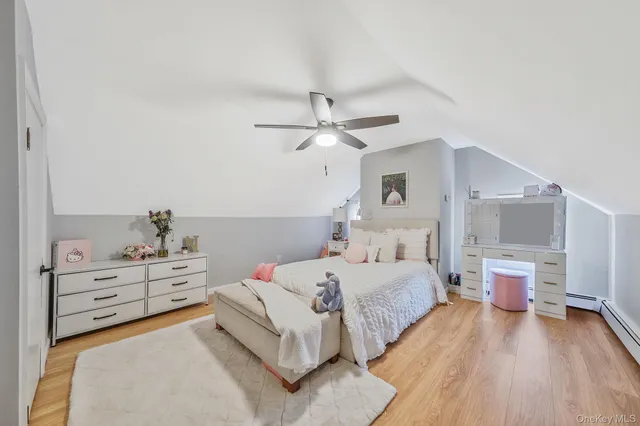 a bedroom with a bed and ceiling fan