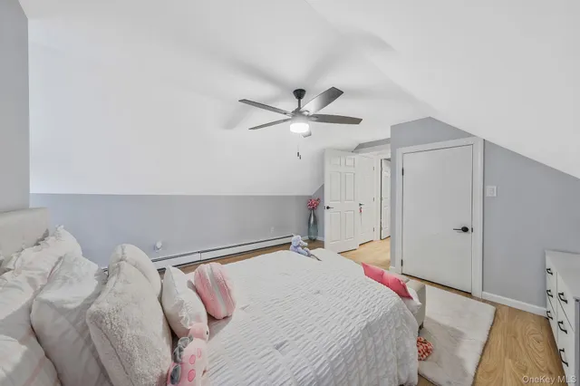 a bed room with a bed and a ceiling fan