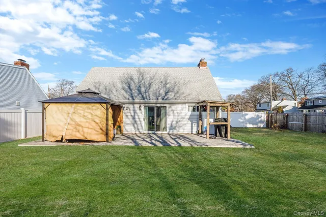 a view of a house with a backyard porch and sitting area