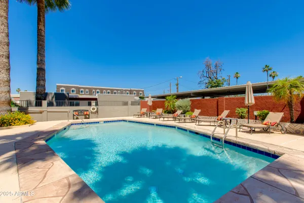 a view of a backyard with swimming pool
