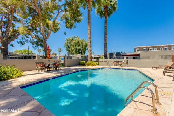 a view of swimming pool with a lounge chair