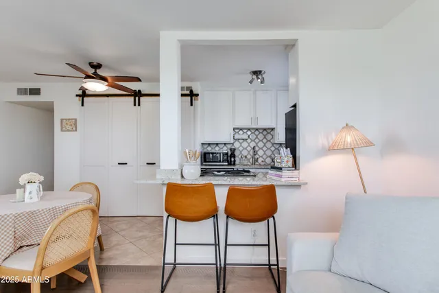 a view of a livingroom with furniture and a window