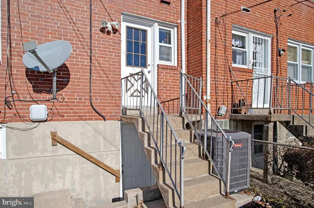 a view of front door of house and outdoor space