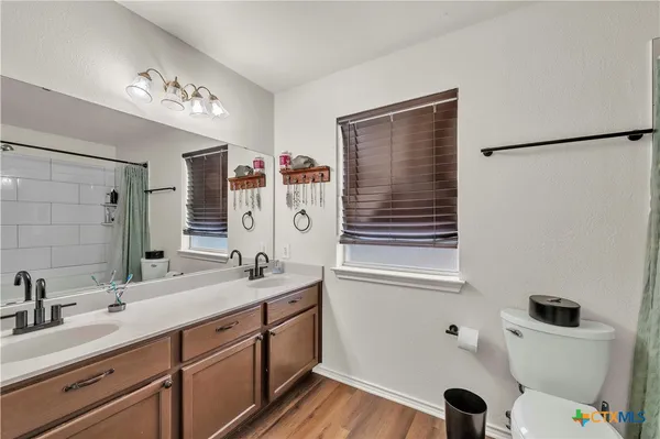 a spacious bathroom with a sink mirror vanity and toilet