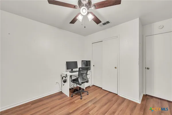 a view of workspace with wooden floor and windows