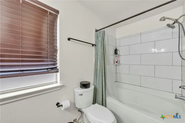 a bathroom with a toilet and a bathtub
