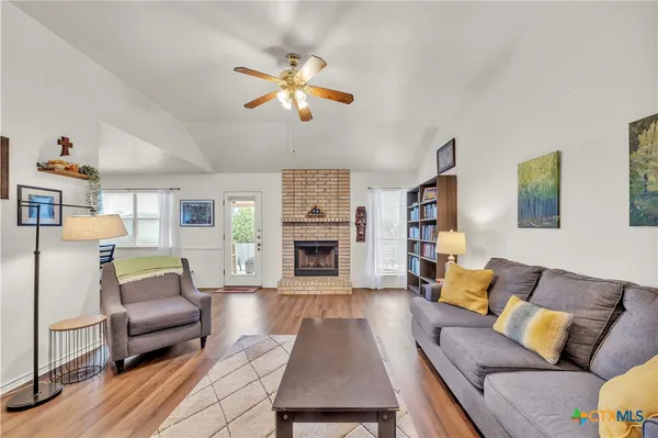 a living room with furniture and a fireplace