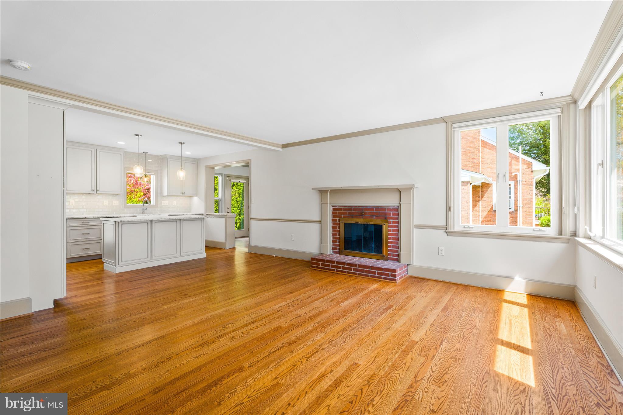 417 Biggs Avenue Frederick, MD 21702 - Photo 2 of 57 an empty room with wooden floor and fireplace